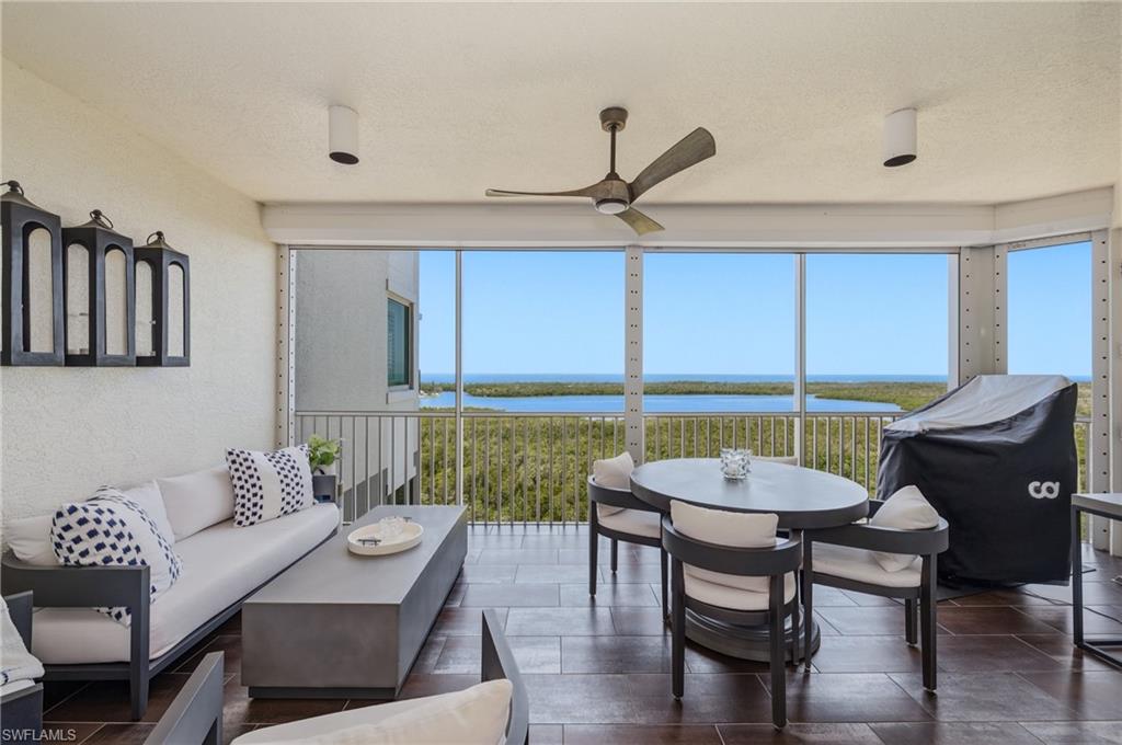 265 Indies Way, Unit 1004 Naples, FL 34110 - Photo 22 of 34 a living room with furniture and a large window