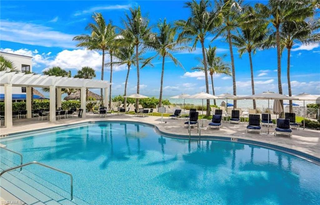 265 Indies Way, Unit 1004 Naples, FL 34110 - Photo 31 of 34 a view of a swimming pool with chairs
