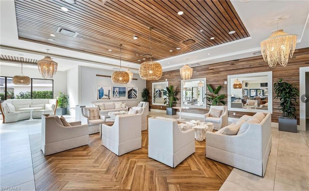 265 Indies Way, Unit 1004 Naples, FL 34110 - Photo 32 of 34 a living room with furniture and a chandelier
