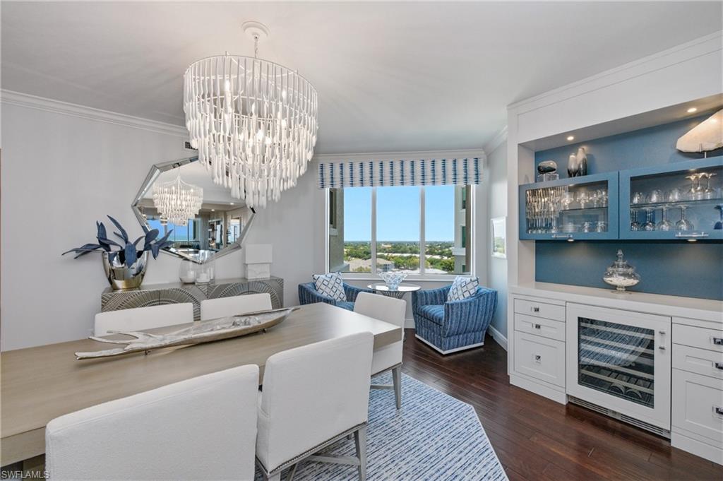 265 Indies Way, Unit 1004 Naples, FL 34110 - Photo 6 of 34 a living room with furniture a chandelier and kitchen view