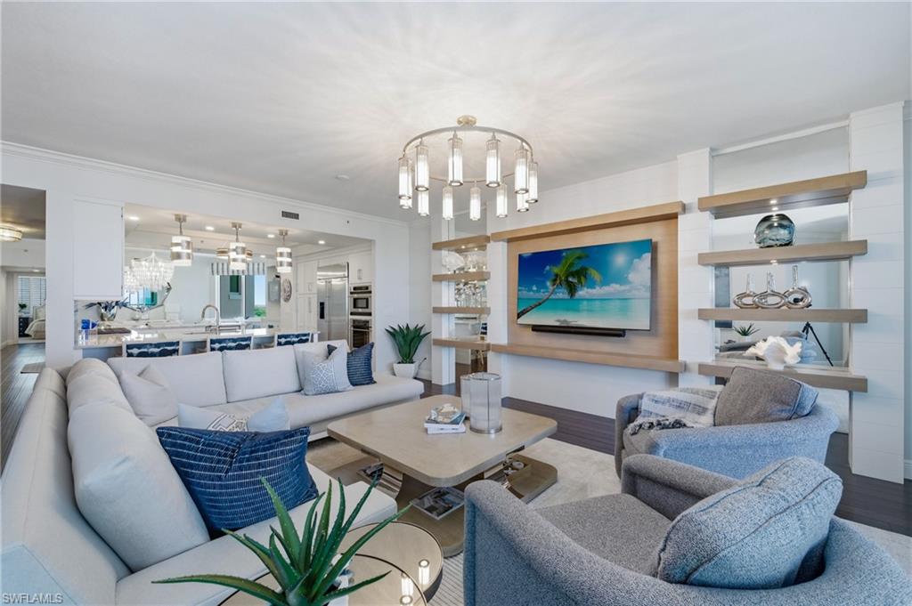 265 Indies Way, Unit 1004 Naples, FL 34110 - Photo 8 of 34 a living room with furniture and a chandelier