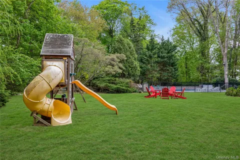 a backyard of a house with wooden floor and fence