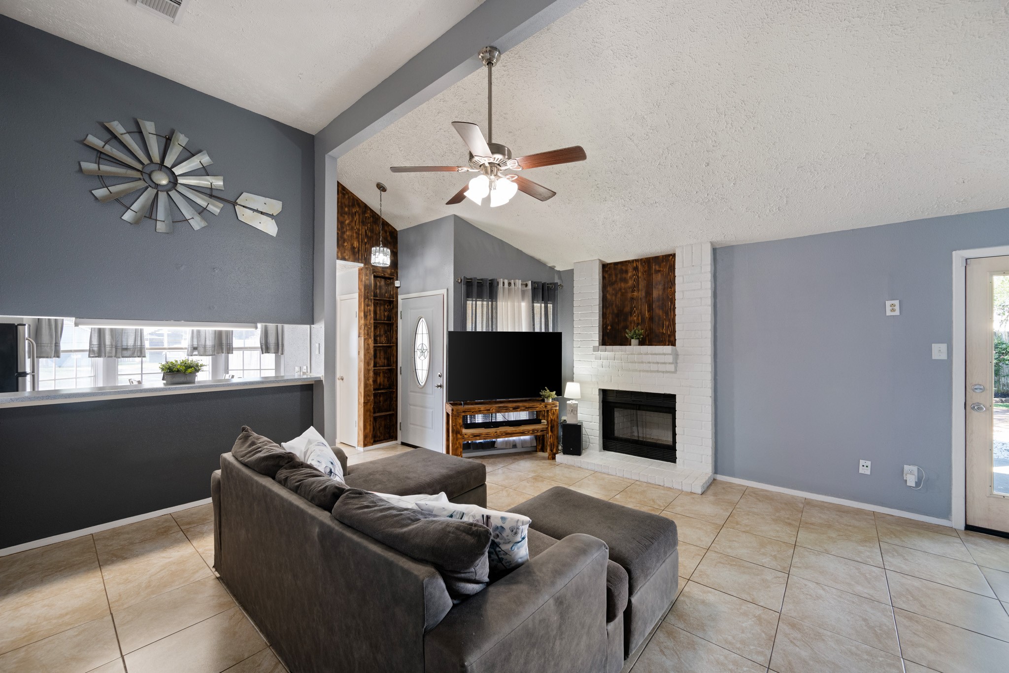 1804 Spruce Drive Rosenberg, TX 77471 - Photo 5 of 29 a living room with furniture a fireplace and a flat screen tv