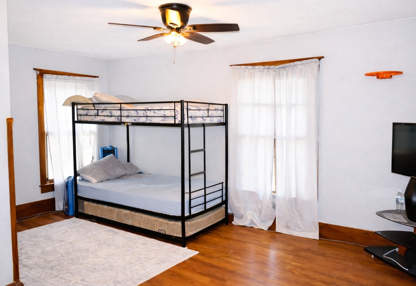112 7th Avenue Sterling, IL 61081 - Photo 17 of 18 a bedroom with a bed and wooden floor