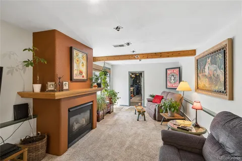 a living room with furniture and flowers