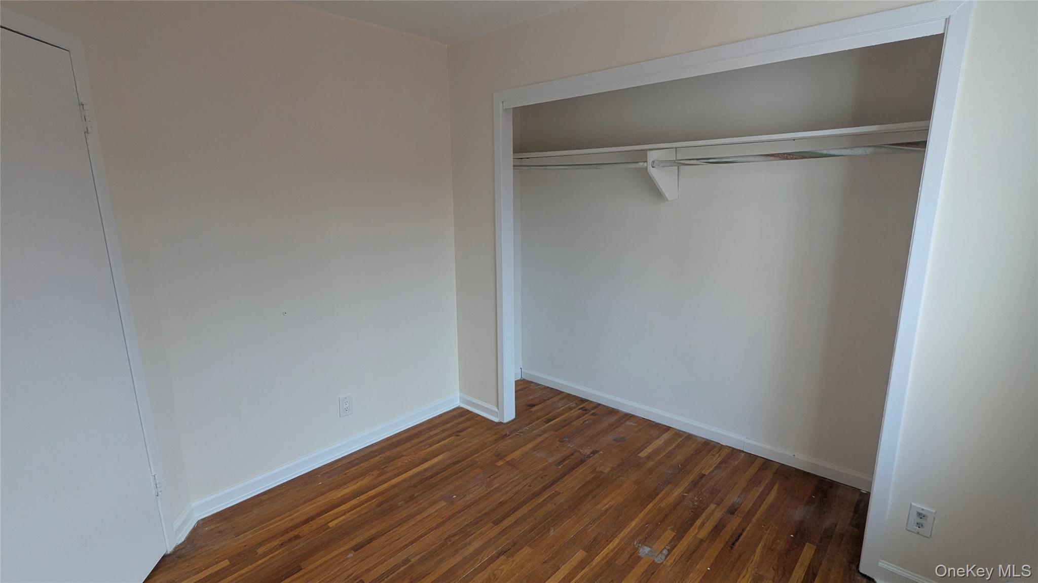 99-47 62nd Road Queens, NY 11374 - Photo 14 of 21 Unfurnished bedroom featuring dark wood-type flooring and a closet