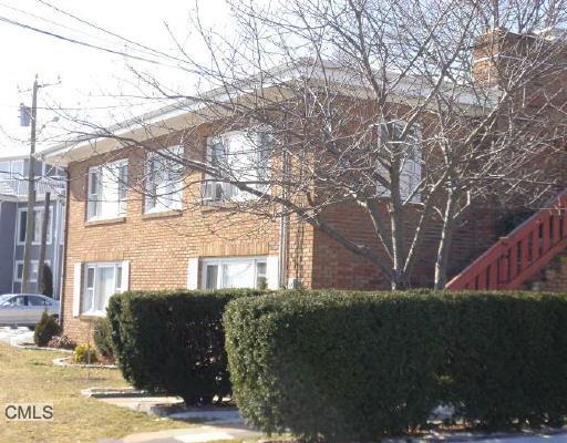 90 Iroquois Road Stamford, CT 06902 - Photo 1 of 1 a front view of a house with a yard