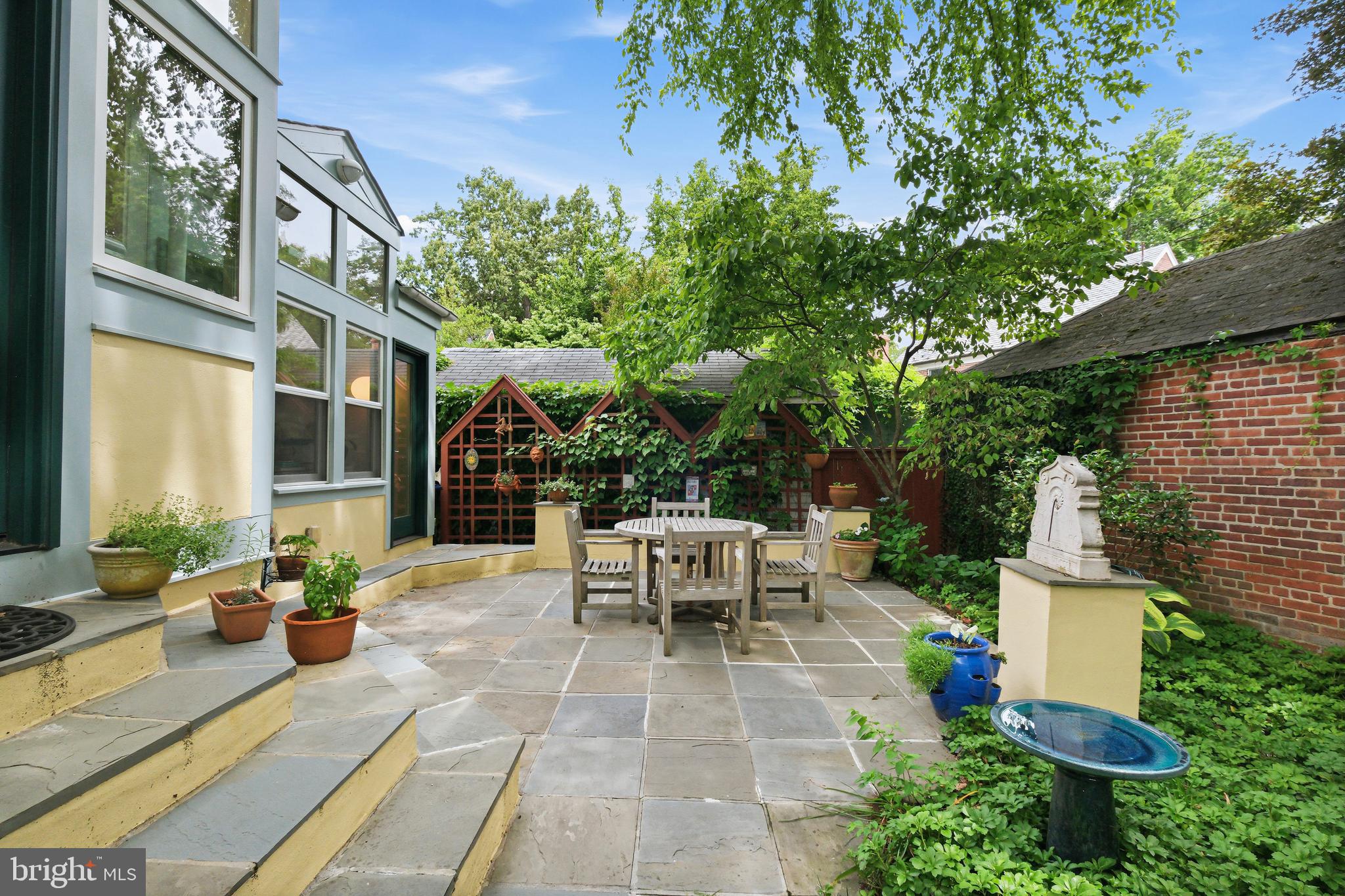 6411 33rd Street Northwest Washington, DC 20015 - Photo 40 of 48 a view of a patio with table and chairs potted plants and large tree