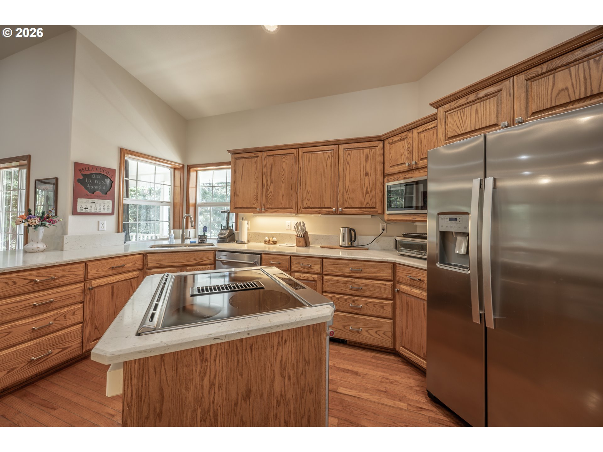2193 13th Street Florence, OR 97439 - Photo 23 of 48 a kitchen with kitchen island a counter top space a sink stainless steel appliances and cabinets