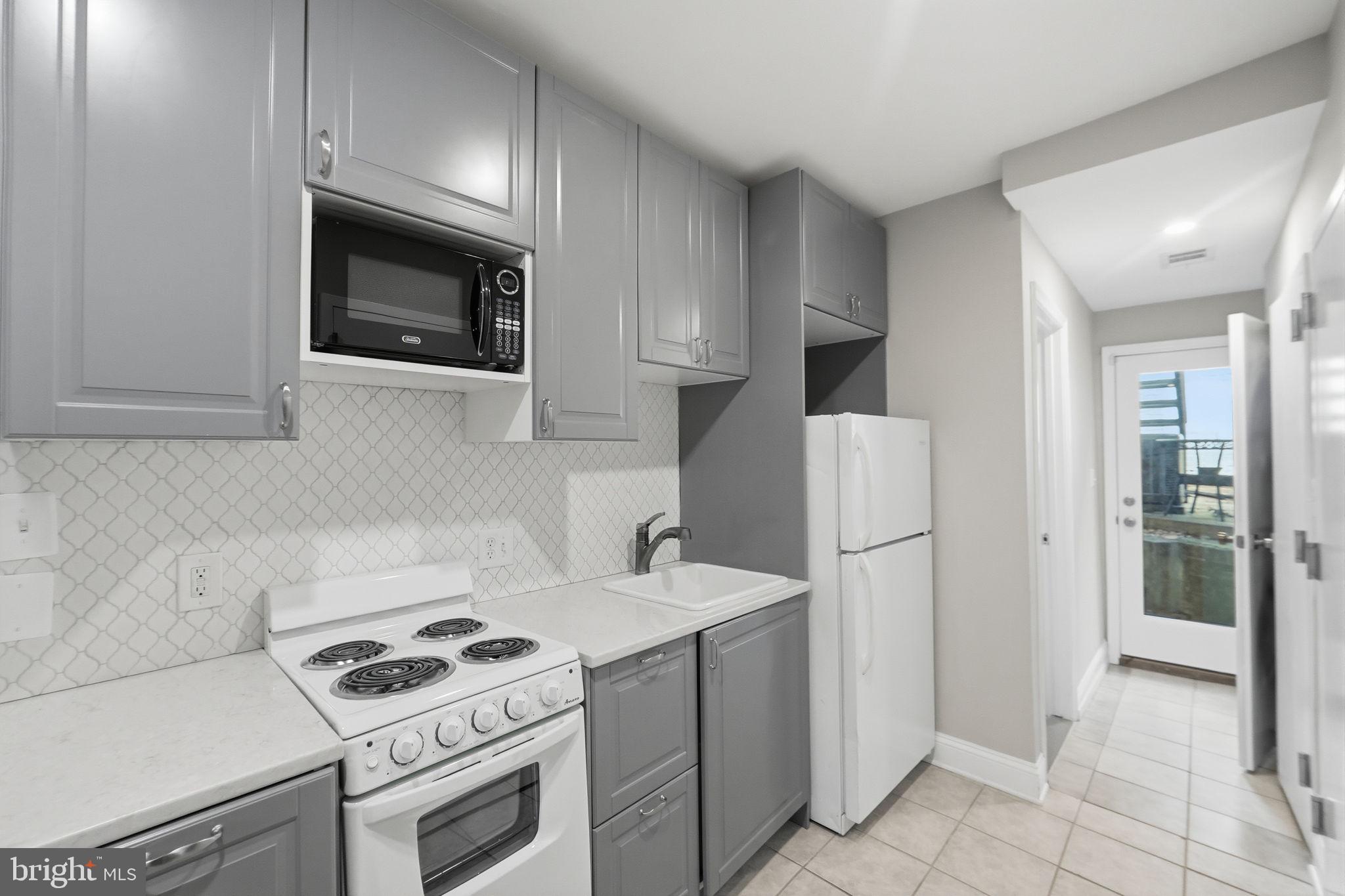 706 12th Street Northeast Washington, DC 20002 - Photo 34 of 49 a kitchen with a stove and a microwave