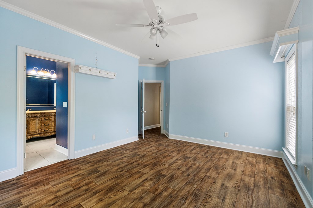 7031 Mellwood Road Columbus, GA 31904 - Photo 11 of 15 a view of an empty room with a window and wooden floor