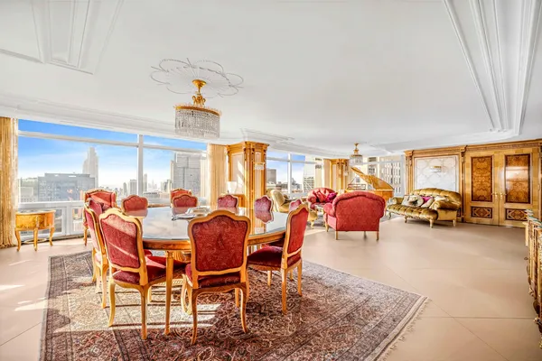 a view of a dining room with furniture and a chandelier