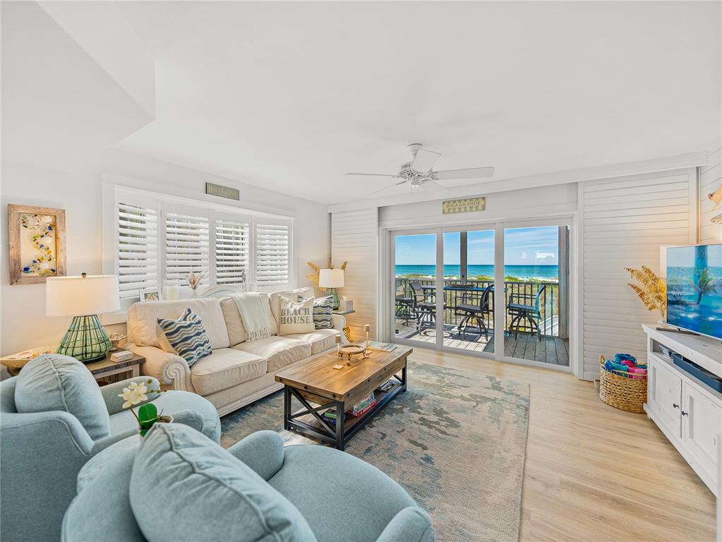 420 Gulf Boulevard, Unit 4 Boca Grande, FL 33921 - Photo 14 of 40 a living room with furniture and a large window