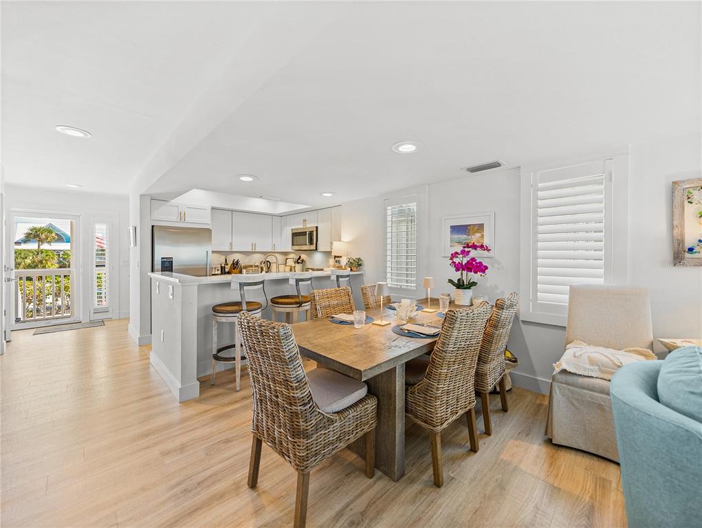 420 Gulf Boulevard, Unit 4 Boca Grande, FL 33921 - Photo 15 of 40 a view of a dining room with furniture and wooden floor