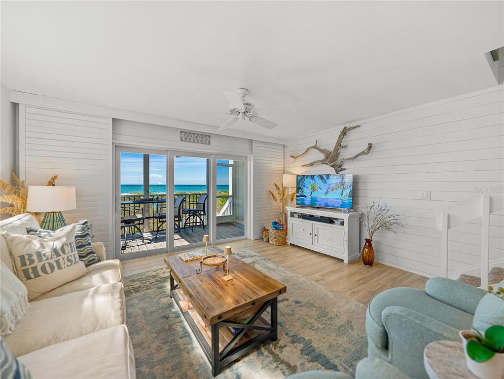 420 Gulf Boulevard, Unit 4 Boca Grande, FL 33921 - Photo 17 of 40 a living room with furniture a window and a flat screen tv