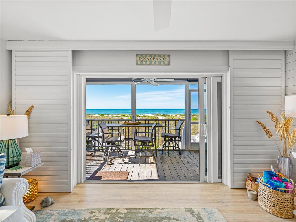 420 Gulf Boulevard, Unit 4 Boca Grande, FL 33921 - Photo 18 of 40 a view of a porch with a table and chairs