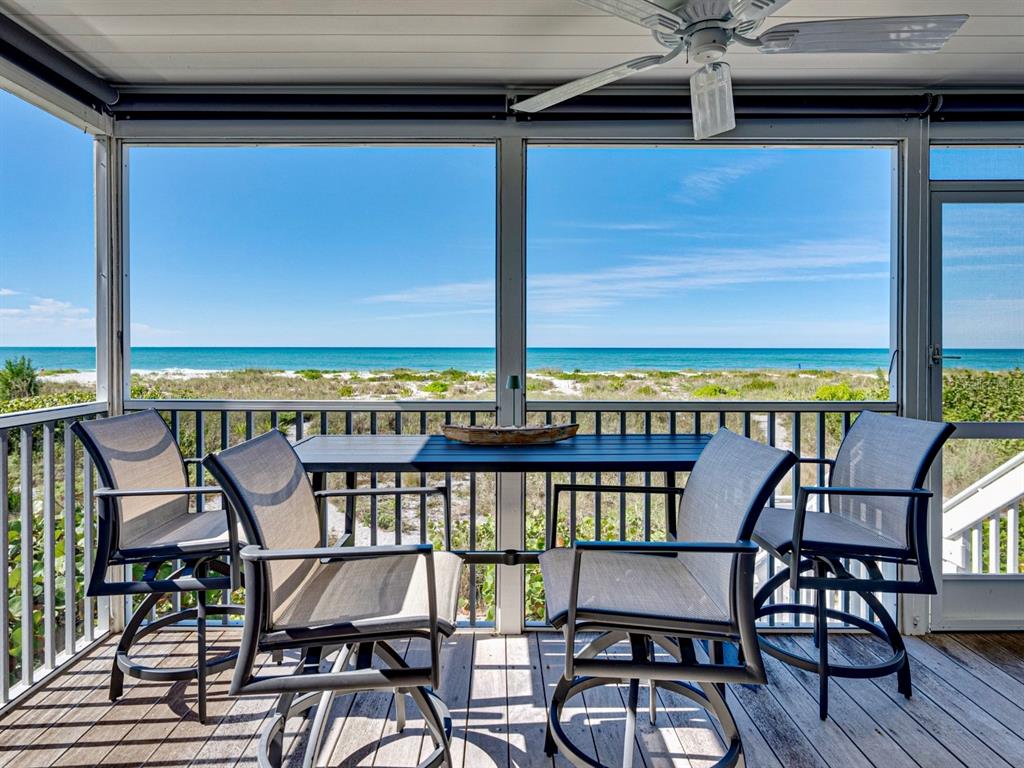 420 Gulf Boulevard, Unit 4 Boca Grande, FL 33921 - Photo 21 of 40 a view of a chairs and table in the balcony