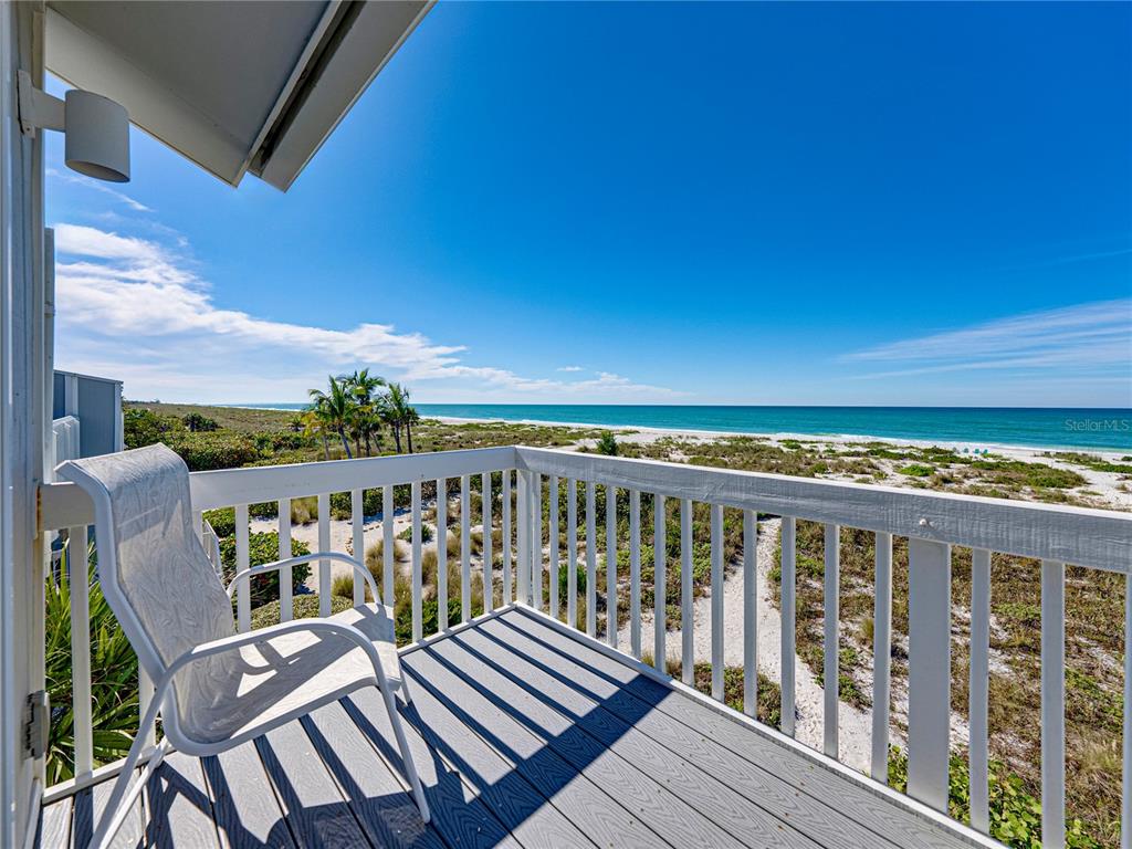 420 Gulf Boulevard, Unit 4 Boca Grande, FL 33921 - Photo 31 of 40 a view of a balcony with wooden floor and furniture