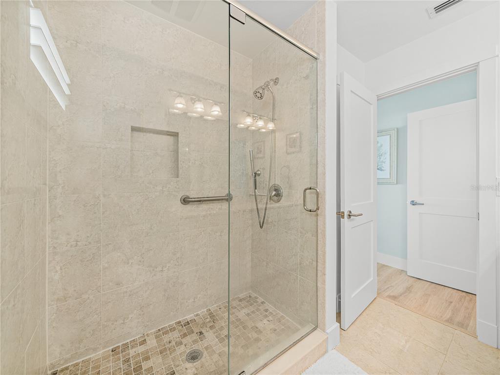420 Gulf Boulevard, Unit 4 Boca Grande, FL 33921 - Photo 33 of 40 a bathroom with a glass shower door