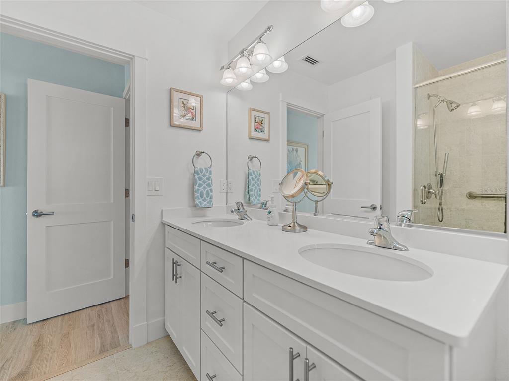 420 Gulf Boulevard, Unit 4 Boca Grande, FL 33921 - Photo 34 of 40 a bathroom with 2 sink and a mirror