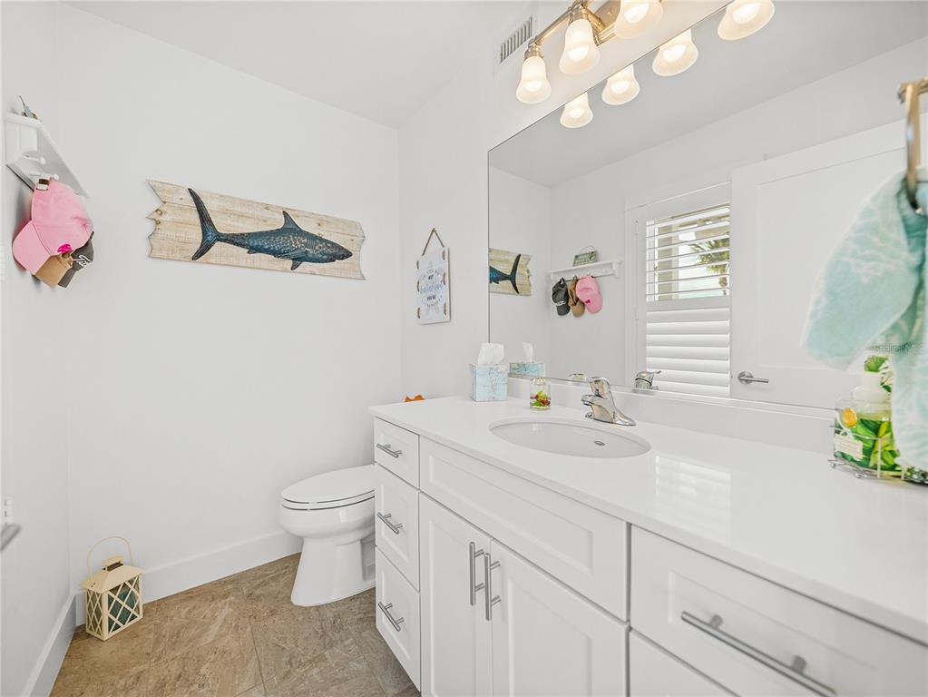 420 Gulf Boulevard, Unit 4 Boca Grande, FL 33921 - Photo 36 of 40 a bathroom with a sink a toilet and a mirror