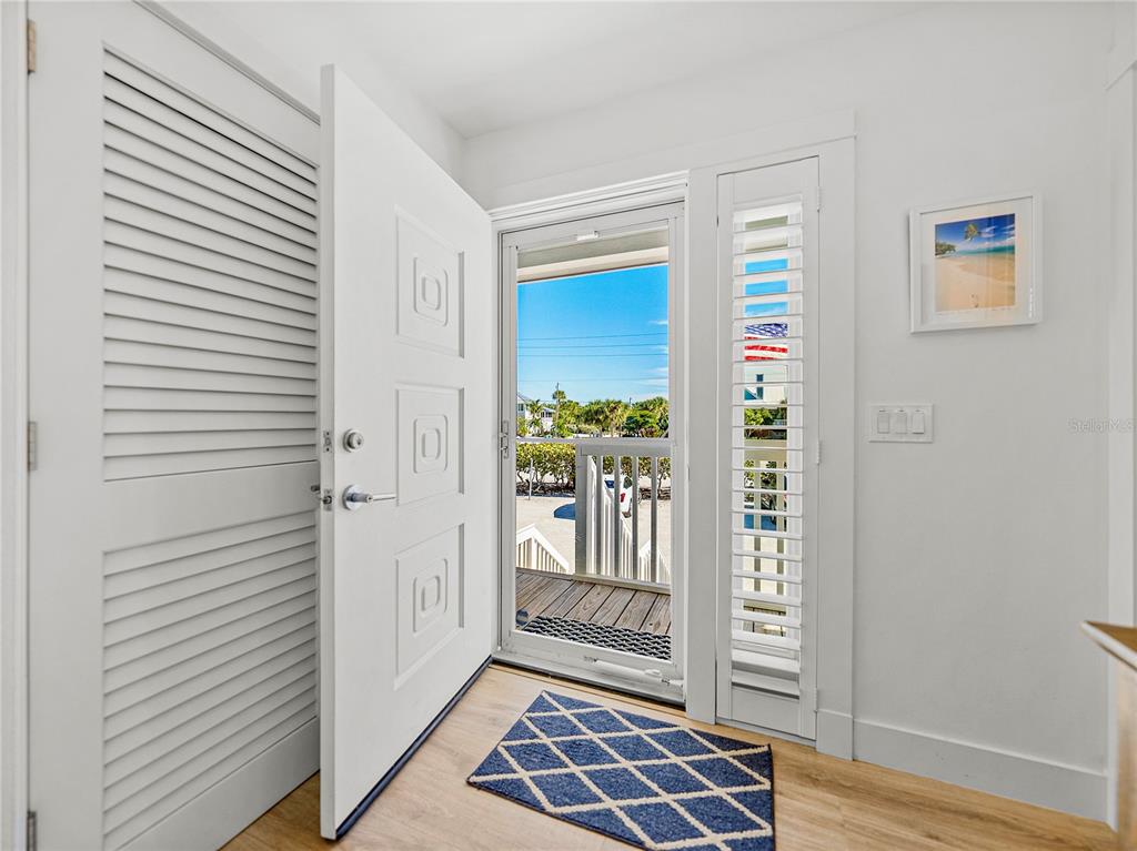 420 Gulf Boulevard, Unit 4 Boca Grande, FL 33921 - Photo 37 of 40 a view of a hallway with wooden floor and windows