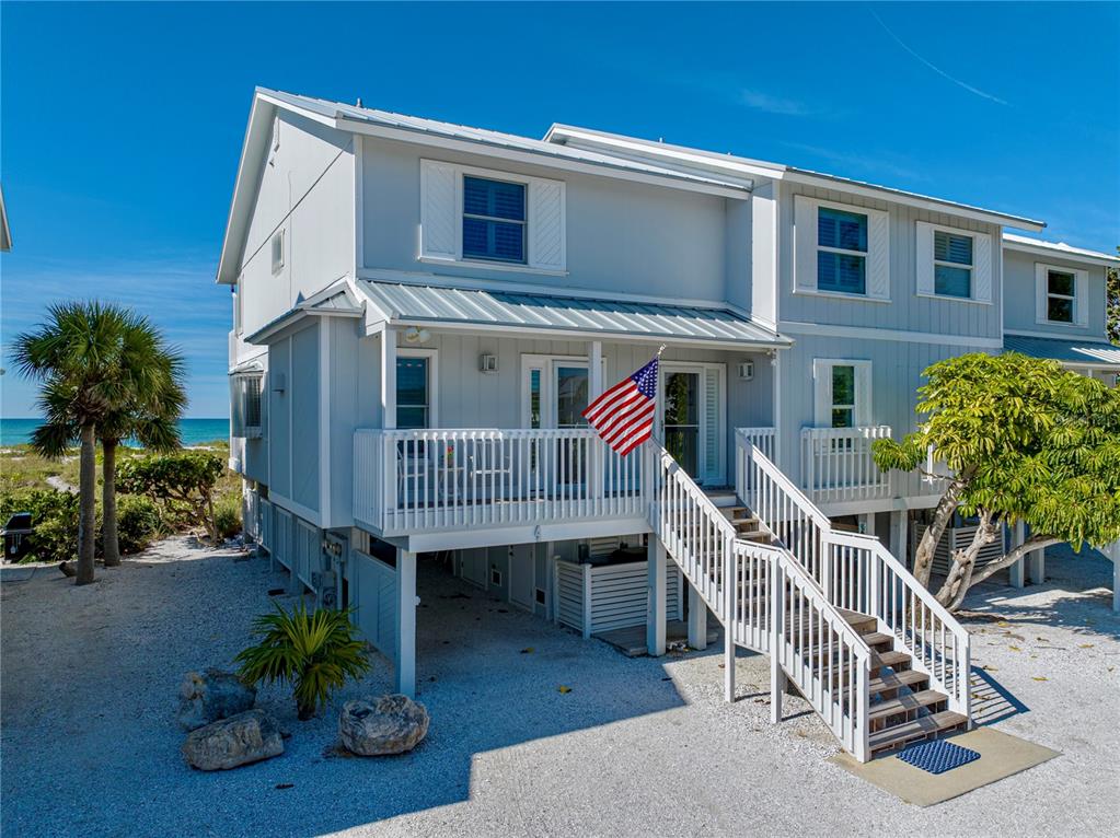 420 Gulf Boulevard, Unit 4 Boca Grande, FL 33921 - Photo 4 of 40 a view of a house with wooden deck and furniture