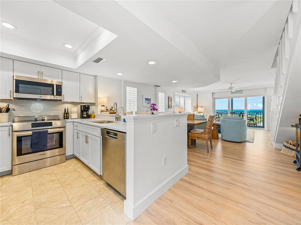 420 Gulf Boulevard, Unit 4 Boca Grande, FL 33921 - Photo 5 of 40 a kitchen with a sink stainless steel appliances and cabinets