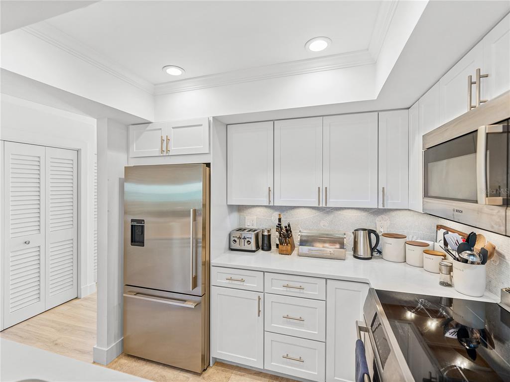 420 Gulf Boulevard, Unit 4 Boca Grande, FL 33921 - Photo 9 of 40 a kitchen with refrigerator cabinets and counter space