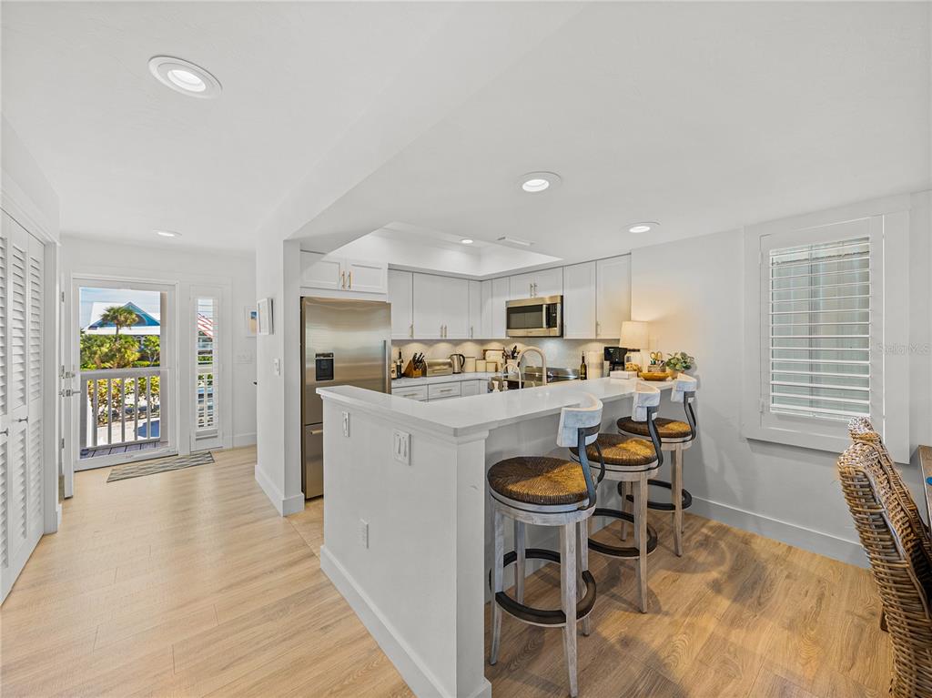 420 Gulf Boulevard, Unit 4 Boca Grande, FL 33921 - Photo 9 of 40 a kitchen with a sink appliances and cabinets