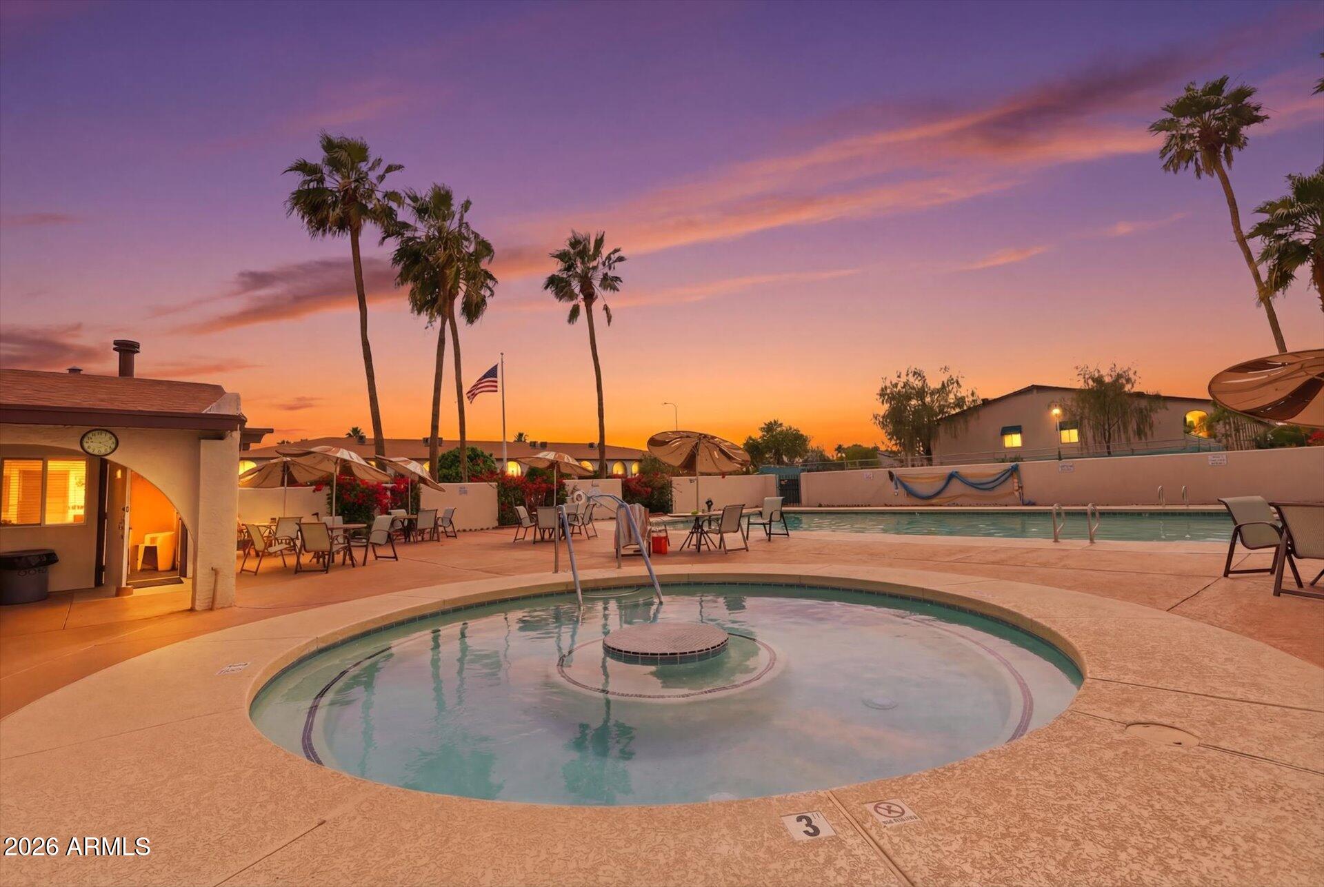 3270 South Goldfield Road, Unit 716 Apache Junction, AZ 85119 - Photo 35 of 36 a view of a swimming pool with a table and chairs