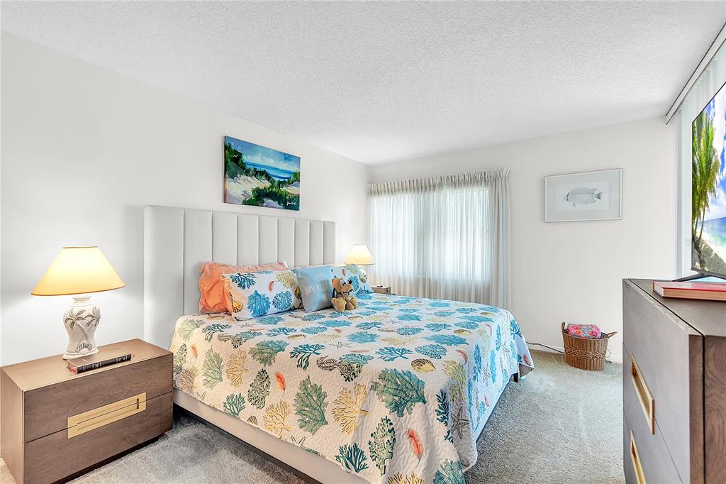 12200 Vonn Road, Unit 2206 Largo, FL 33774 - Photo 32 of 60 a bedroom with a bed and a lamp