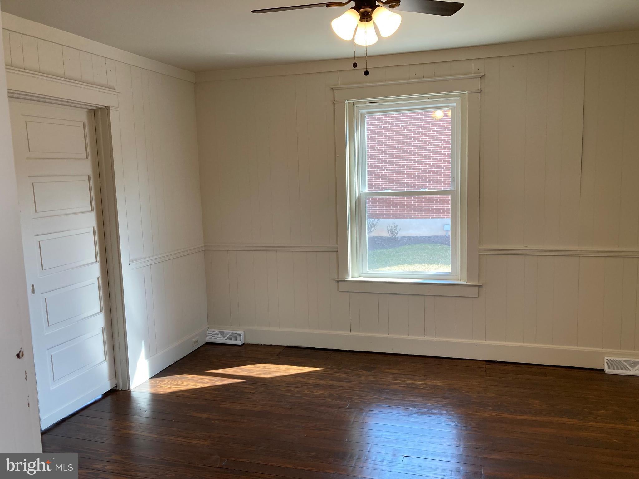 747 Bellevue Avenue Gap, PA 17527 - Photo 15 of 16 an empty room with wooden floor and windows