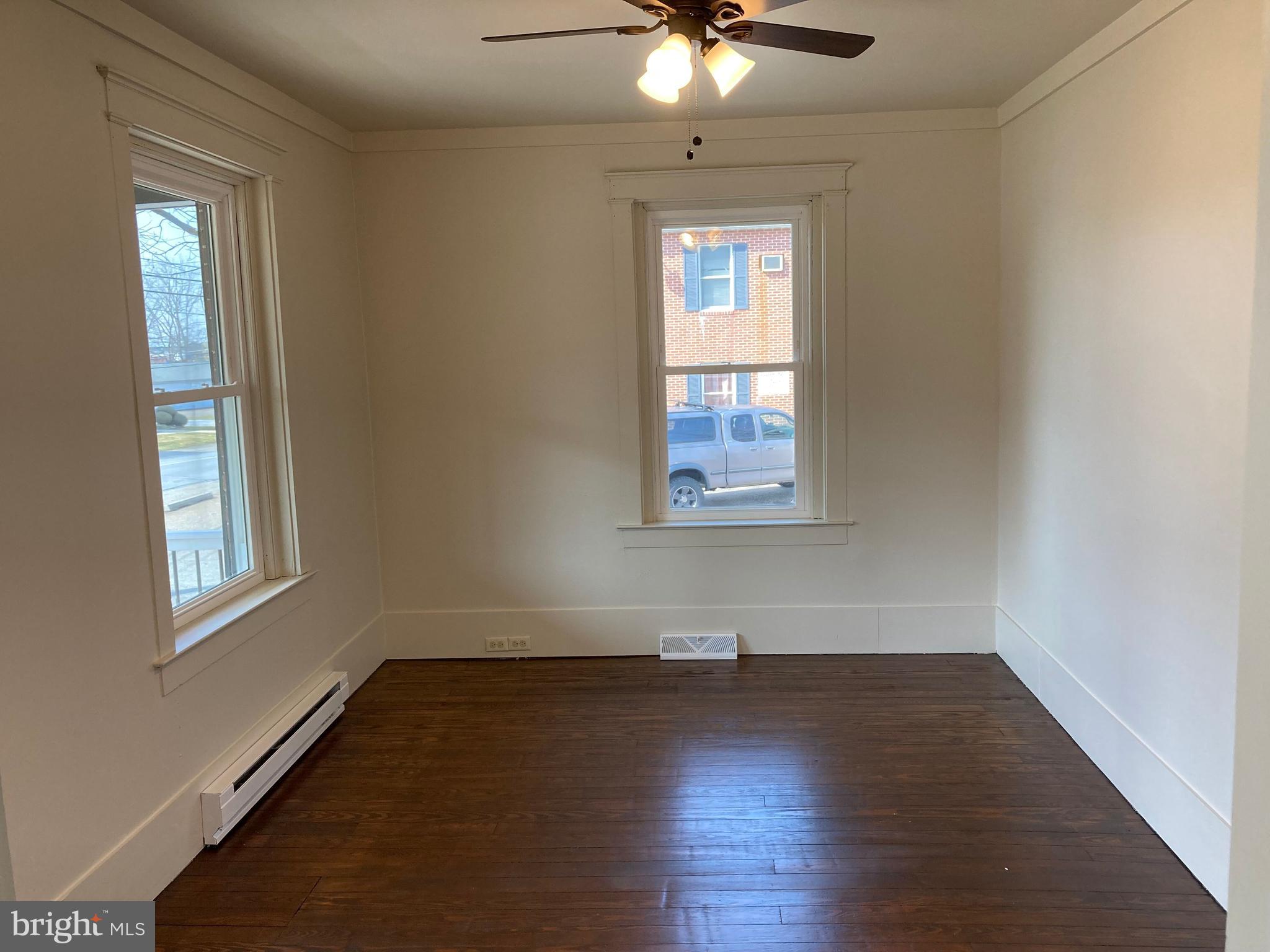 747 Bellevue Avenue Gap, PA 17527 - Photo 16 of 16 an empty room with wooden floor fan and windows