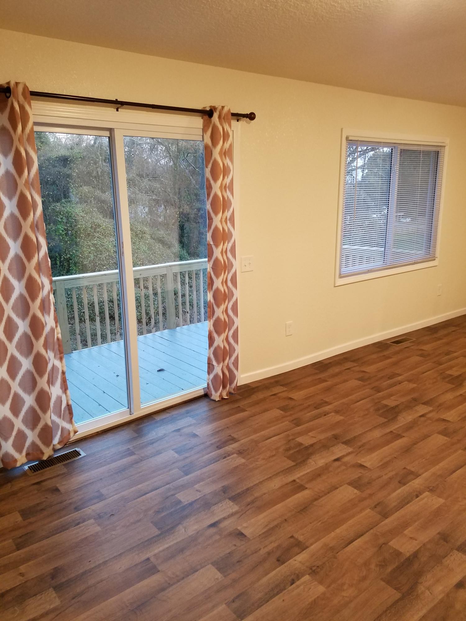 104106 Hunter Circle Oak Ridge, TN 37830 - Photo 2 of 15 a view of an empty room with wooden floor and a window