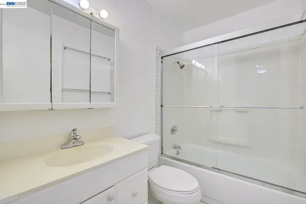 a view of a patio with table and chairs under an umbrella