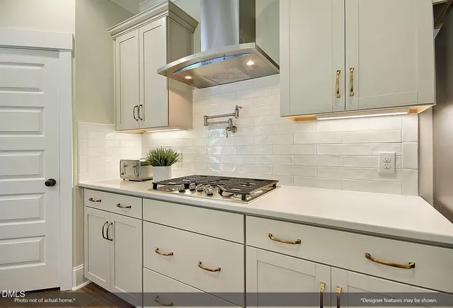 a kitchen with white cabinets and white appliances
