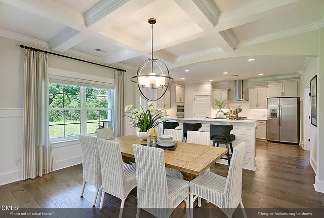 a view of a livingroom with furniture a chandelier and wooden floor