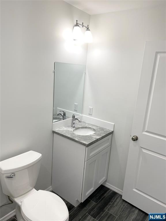 61 Chestnut Street, Unit 2 Lodi, NJ 07644 - Photo 13 of 22 a bathroom with a granite countertop toilet and a sink