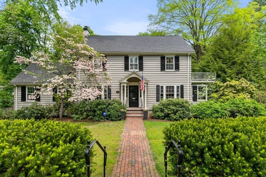 a front view of a house with garden