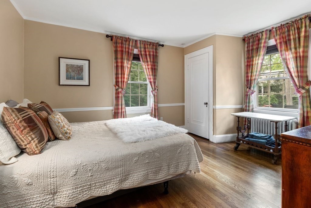 120 Forest Street Wellesley, MA 02481 - Photo 16 of 24 a bedroom with a bed a table and a large window
