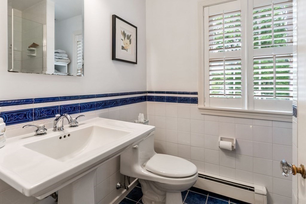 120 Forest Street Wellesley, MA 02481 - Photo 18 of 24 a bathroom with a sink toilet and a mirror