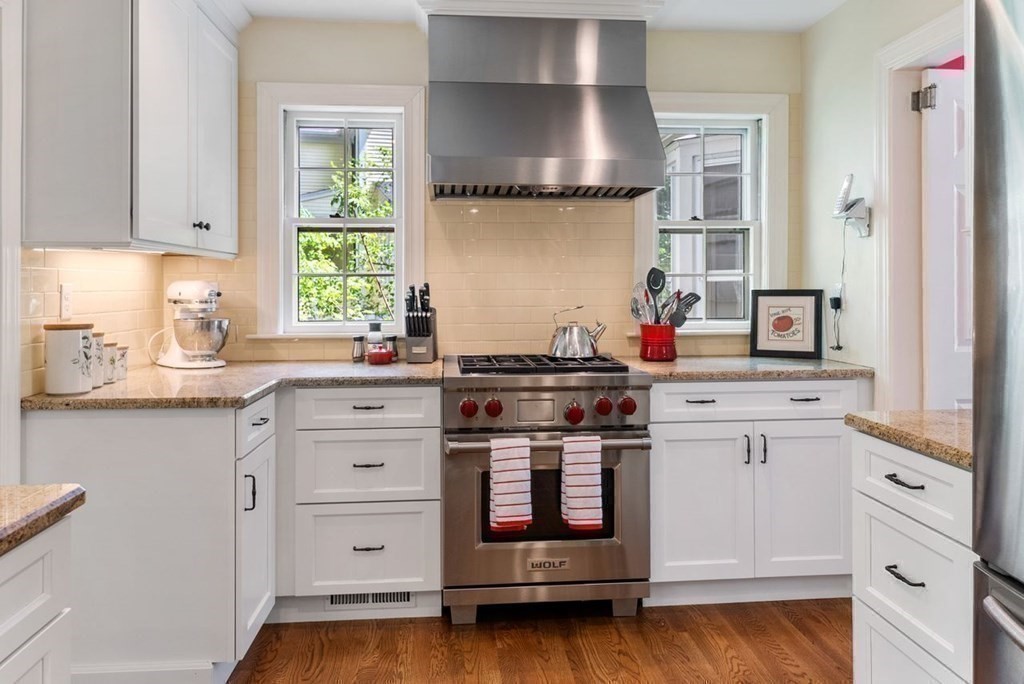 120 Forest Street Wellesley, MA 02481 - Photo 5 of 24 a kitchen with stainless steel appliances granite countertop a stove and white cabinets