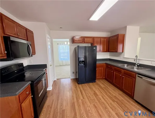 a large kitchen with wooden floors and wooden cabinets
