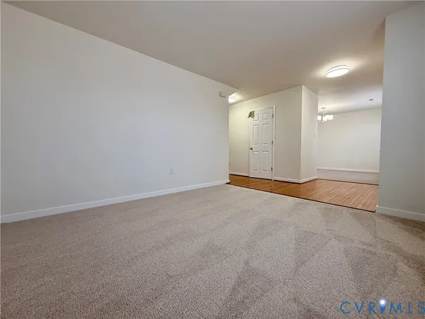 a view of empty room with a ceiling fan and window