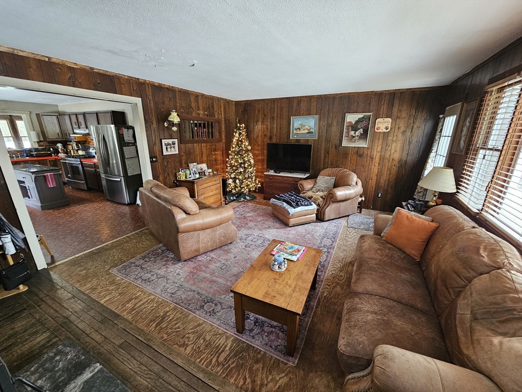 127 Summer Street Thorndike, MA 01079 - Photo 14 of 27 a living room with furniture a flat screen tv and a floor