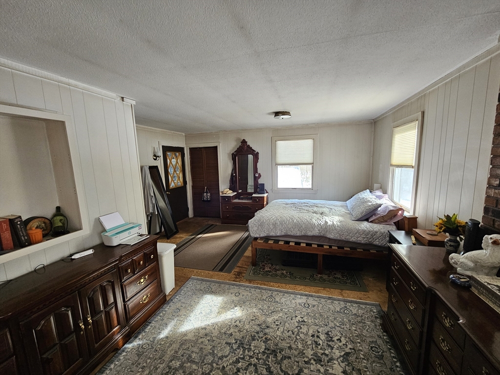 127 Summer Street Thorndike, MA 01079 - Photo 18 of 27 a spacious bedroom with a bed a large window and dresser