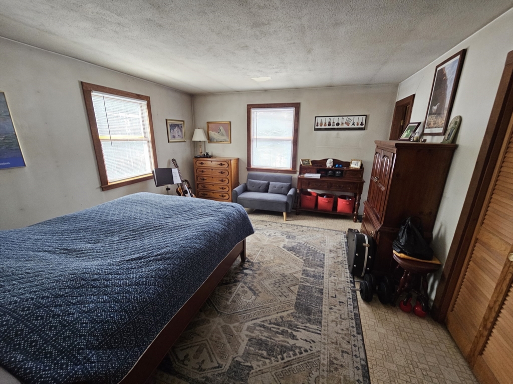 127 Summer Street Thorndike, MA 01079 - Photo 20 of 27 a bedroom with a bed a couch and dresser