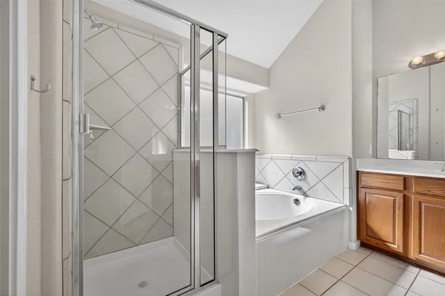 a spacious bathroom with a granite countertop sink a mirror and a vanity