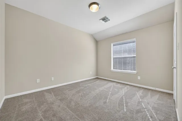 an empty room with windows and outdoor view